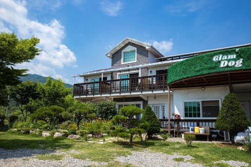 a large house with a green roof at Gapyeong GlamDog Pet Pension in Gapyeong