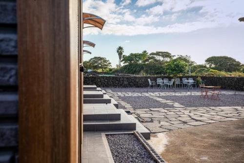 a view of a patio with chairs and tables at Neul Olle Stay in Jeju