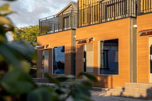 a building with a balcony on the side of it at Neul Olle Stay in Jeju