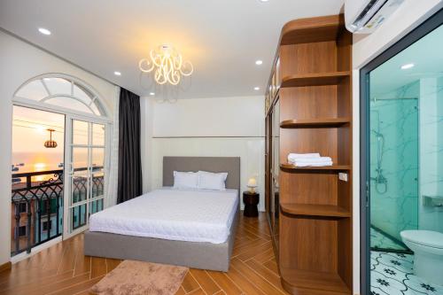 a bedroom with a bed and a bathroom at Sun'House- Family 2BR Apt View Sea & Sunset Town Phu Quoc in Phu Quoc