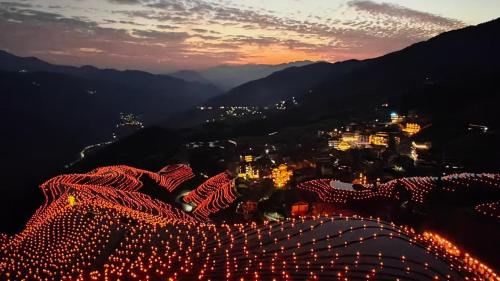 a view of a city at night with christmas lights at Longji B&B in Cloud in Longsheng