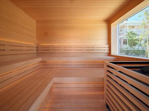 a sauna with wooden floors and a window at アドベンチャーズアイランド 小谷流沢ロッジ in Yachimata
