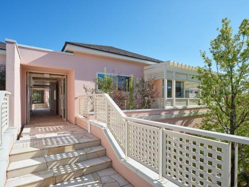 a house with a white railing and stairs at アドベンチャーズアイランド 小谷流沢ロッジ in Yachimata