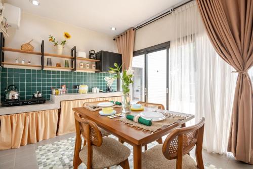 a kitchen with a wooden table and chairs in a room at Casa Candali, Farm Haven - Bogor Short Getaway - Respectful Guest Only in Bogor