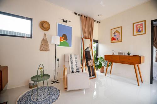 a living room with a table and a desk at Casa Candali, Farm Haven - Bogor Short Getaway - Respectful Guest Only in Bogor