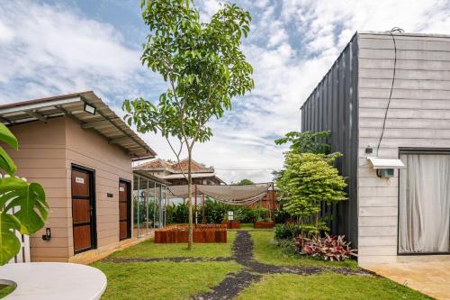 a house with a garden in front of it at Casa Candali, Farm Haven - Bogor Short Getaway - Respectful Guest Only in Bogor