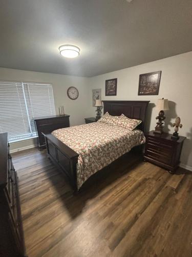 a bedroom with a bed and a wooden floor at Perkins Cove in Baton Rouge