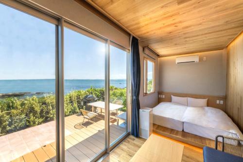 Postel nebo postele na pokoji v ubytování La vista Yokosuka Kannonzaki Terrace