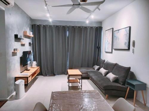 a living room with a couch and a table at Geo Sweet Homestay Kota Kemuning Bukit Rimau in Shah Alam
