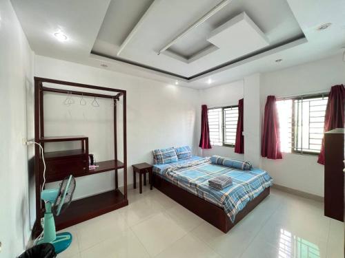 a bedroom with a bed and a mirror in it at The Moonvine on 360 in Phnom Penh