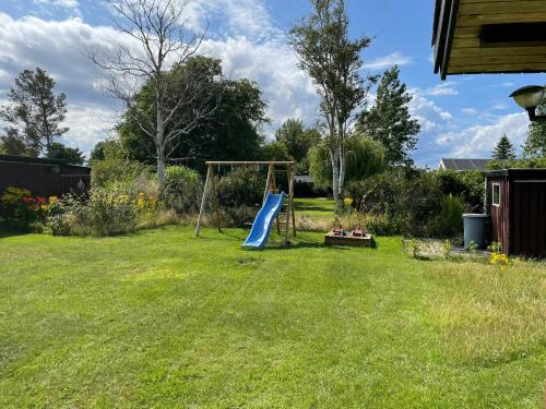 een speeltuin in een tuin met een glijbaan bij Home With Nordic Interior in Korsør