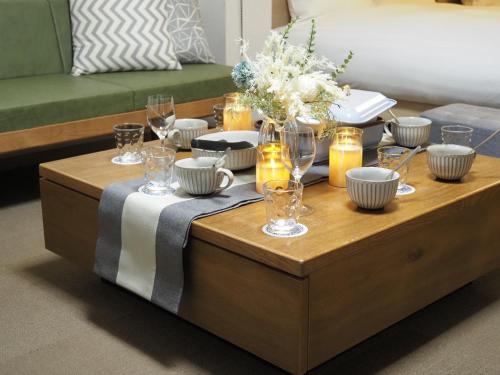 a coffee table with dishes and glasses on it at T-home2 1F in Tokyo