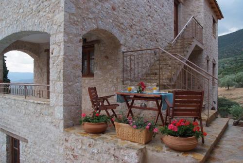 a patio with a table and chairs on a building at Anigraia in Paralion astros