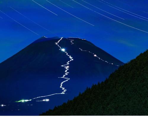 a mountain with lights on top of it at night at Eishinan 栄進庵 in Fuji