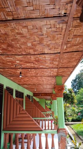 a wooden ceiling on a building with a staircase at Wisma Batu Mandi in Bukit Lawang
