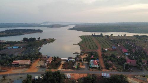 an aerial view of a town and a river at Cardamom Community Center in Moăt Preăh