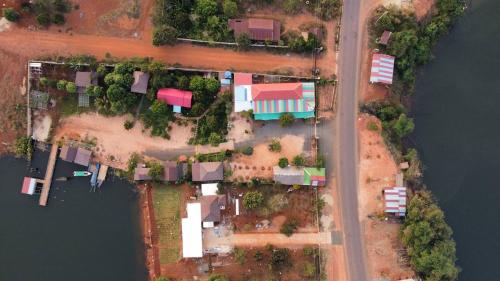 an aerial view of a house next to the water at Cardamom Community Center in Moăt Preăh