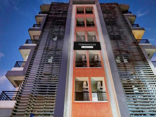 a tall building with a sign on the side of it at Super Townhouse Hinjewadi in Pune