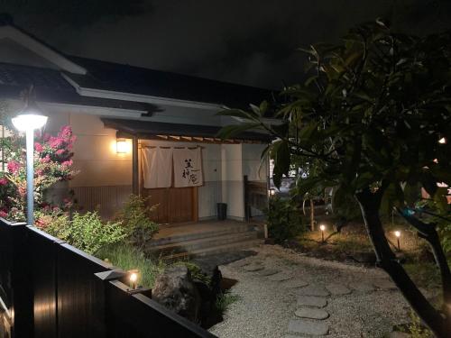 a house at night with a light on the porch at 笠神庵 in Tagajo