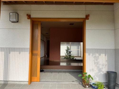 an open door of a house with a plant at 笠神庵 in Tagajo