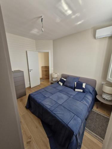 a bedroom with a large blue bed in a room at Finestra sul Golfo in Mondello
