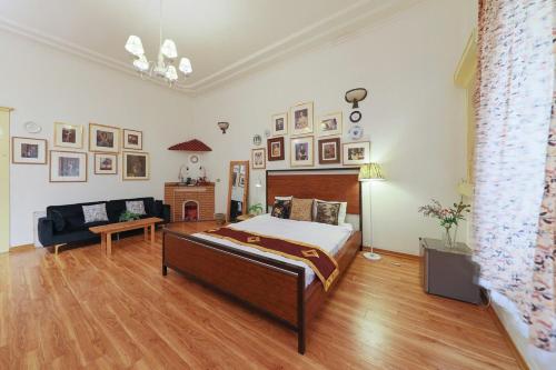 a bedroom with a bed and a couch and a fireplace at Cozy Fun Homestay 12 in Hanoi