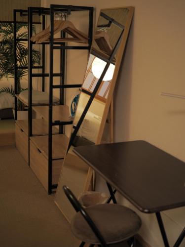 a desk and a chair in a room with bunk beds at T-home2 1F in Tokyo