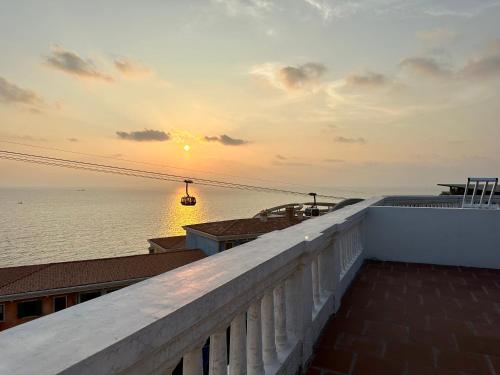 a view of the ocean from a balcony at sunset at Sun'House- Family 2BR Apt View Sea & Sunset Town Phu Quoc in Phu Quoc