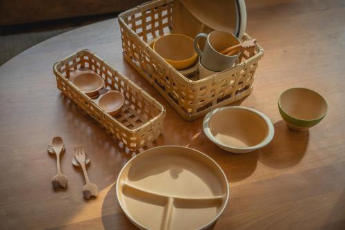 a table with baskets and utensils on a table at LAMP Nojiriko The Sauna by the Lake in Shinano