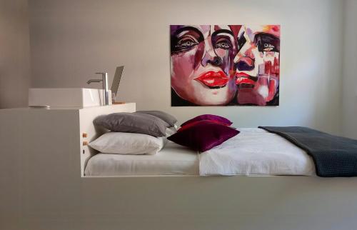 a bedroom with a bed with a painting on the wall at Minimalist Style Apartment In Upper Palatinate in Neunburg vorm Wald