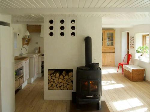 a kitchen with a wood stove in a room at Charming Farmhouse From 1875 Near Stevns Klint in Rødvig