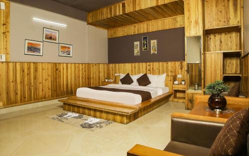 a hotel room with a bed and a couch at Mount Queens Hill Resort & Spa in Mirik
