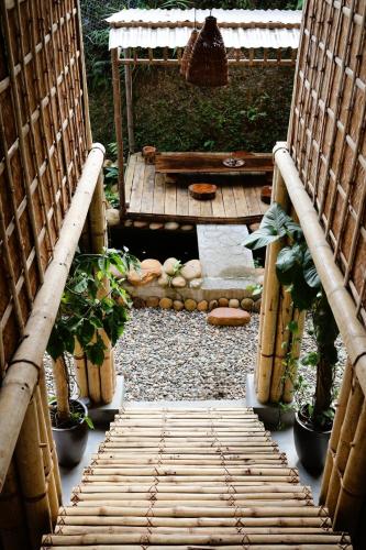 a walkway leading to a garden with plants and a bench at Dinh Gia Trang - Homestay & Coffee in Yên Bái