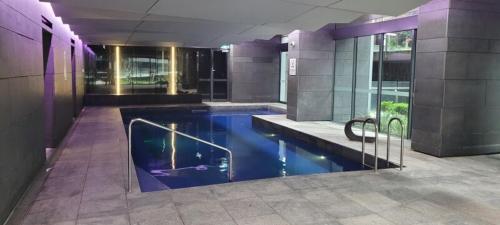 a large building with a swimming pool in a building at Cozy Oasis L1708 with Swimming Pool in Melbourne