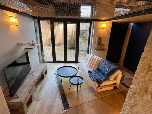 a living room with a couch and a table at Charmant Duplex in Saint-Didier-au-Mont-dʼOr
