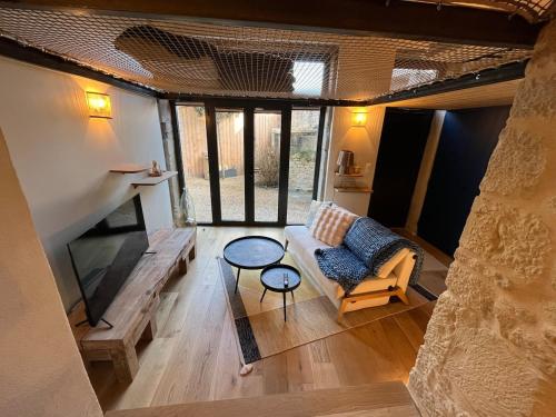 a living room with a couch and a table at Charmant Duplex in Saint-Didier-au-Mont-dʼOr