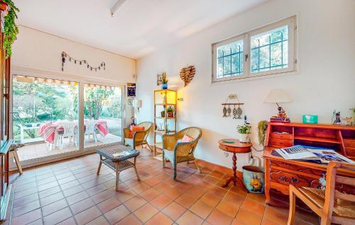 ein Wohnzimmer mit einem Schreibtisch, Stühlen und einem Tisch in der Unterkunft Amazing Home In Meschers-Sur-Gironde in Meschers-sur-Gironde