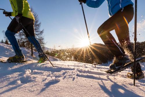 two people on skis in the snow at Hotel Gailtaler Hof in Kötschach