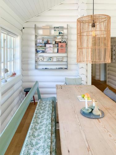 a dining room with a wooden table and chairs at Nordic Exclusive Log House On The North Coast in Tisvildeleje