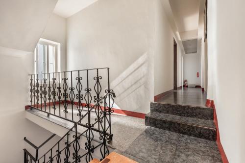a staircase in a house with white walls at Rich House B&B in Kenting