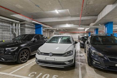 a parking garage with cars parked in at Crown Beach Escape - Stylish Comfort by the Sea in Wollongong