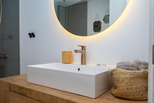 a bathroom with a white sink and a mirror at Casa Vista Bonita in Port de Soller