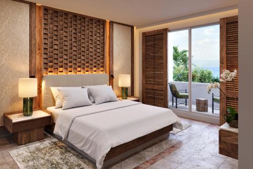 Un dormitorio con una cama grande y una ventana grande. en Paraiso de la Bonita Adult All-Inclusive, a Luxury Collection Resort, en Puerto Morelos