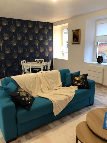 un canapé bleu dans un salon avec une table dans l'établissement Apartment Boulogne sur mer, à Boulogne-sur-Mer