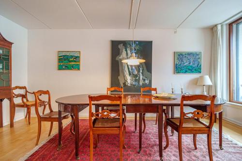 a dining room with a table and chairs at Spacious Canal-View Apartment Near Metro in Christianshavn in Copenhagen