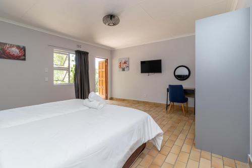Ένα ή περισσότερα κρεβάτια σε δωμάτιο στο Grand Manor Self Catering Muldersdrift