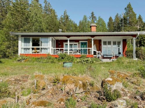 a house on the side of a field at Lake View Holiday Home With Natural Charm in Storfors