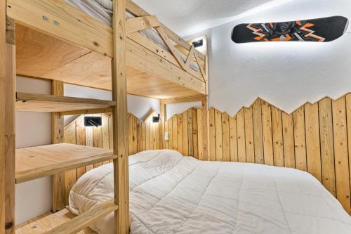 - une chambre avec 2 lits superposés et des murs en bois dans l'établissement Résidence Les Hauts De Preclaux - Logement rénové en rez-de-jardin avec vue pistes MAE-4491, aux Orres