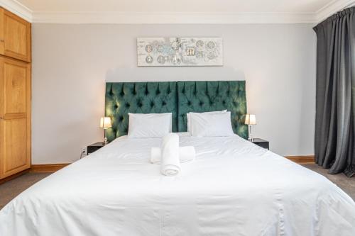 Ένα ή περισσότερα κρεβάτια σε δωμάτιο στο Grand Manor Self Catering Muldersdrift