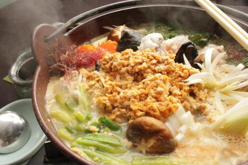 a bowl of soup with meat and vegetables at Isohara Seaside Hotel in Isohara
